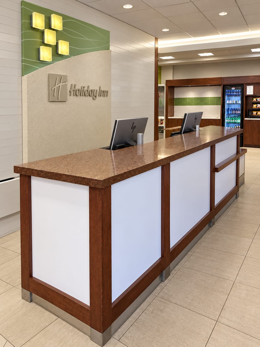 Stone reception counter with wood trim and light front panels